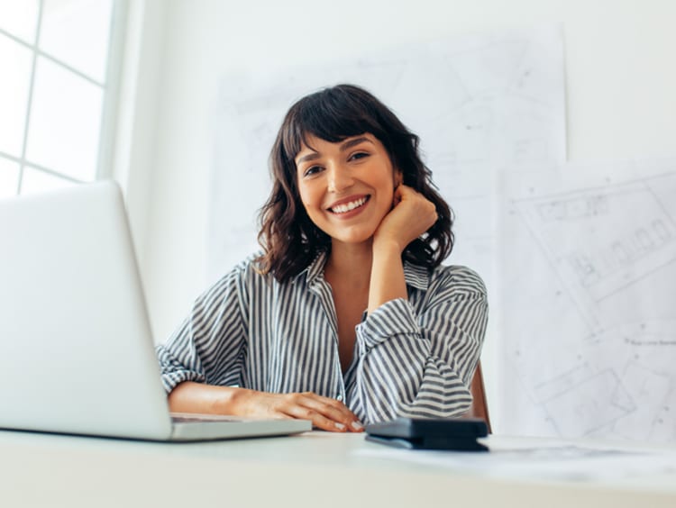 Entrepreneur on laptop smiling