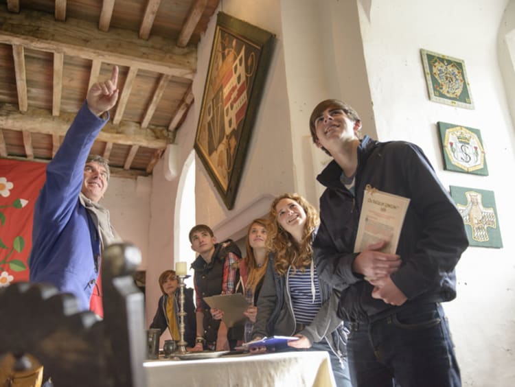 Male tour guide with a group of young tourists