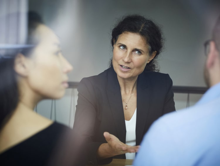 Loan officers meeting with clients in office