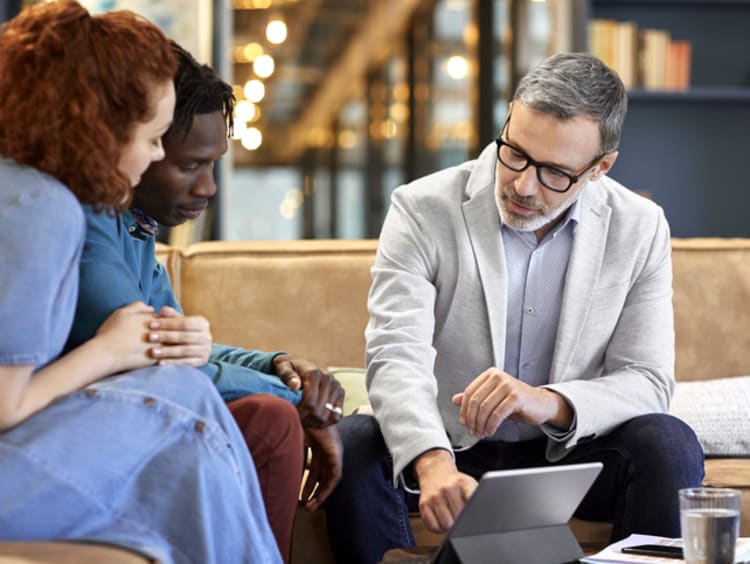 Investment manager helping young couple with their finances 