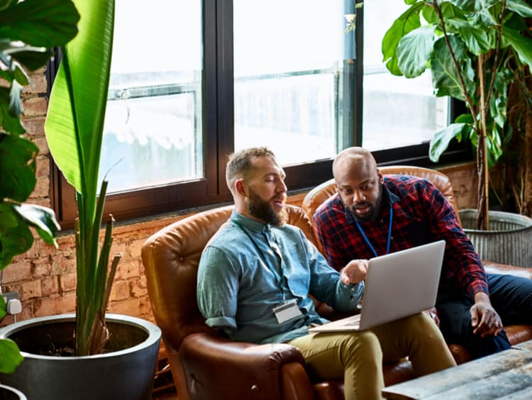 Mentor and mentee working together on laptop