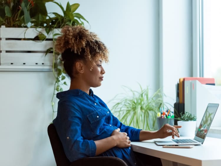 Social media manager working on computer in office