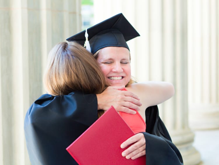 Female doctoral student at graduation after finishing PhD