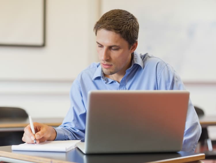 Male doctoral student working on his dissertation thesis 