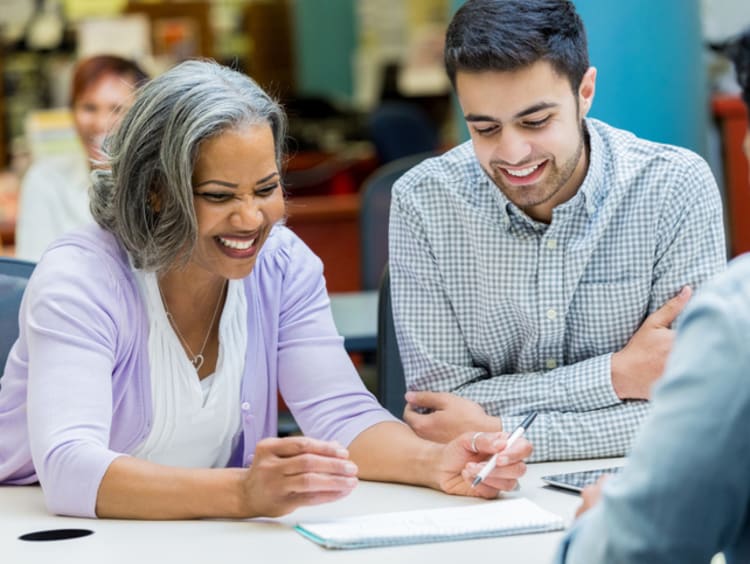 Doctoral students collaborating on an assignment