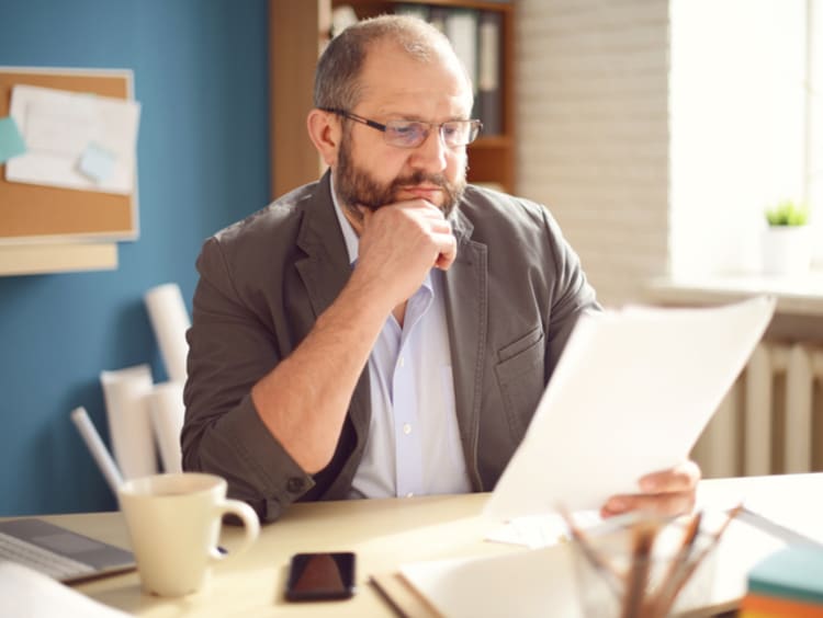 Male doctoral student reviewing records for dissertation research