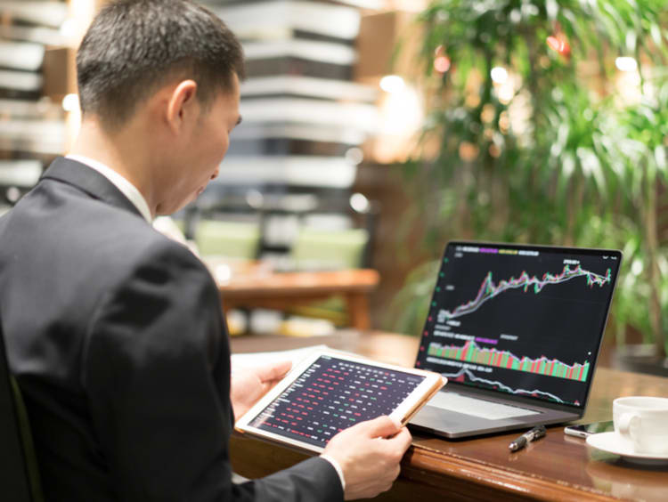 Business professional reviewing quantitative research at desk