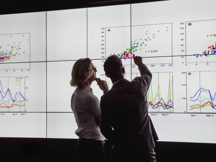 Two PhD students looking at results from a quantitative research design