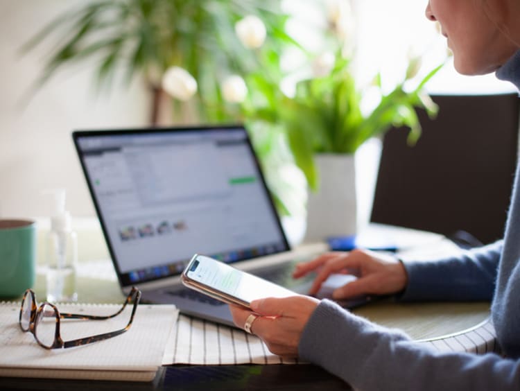 Woman runs some calculations on her laptop