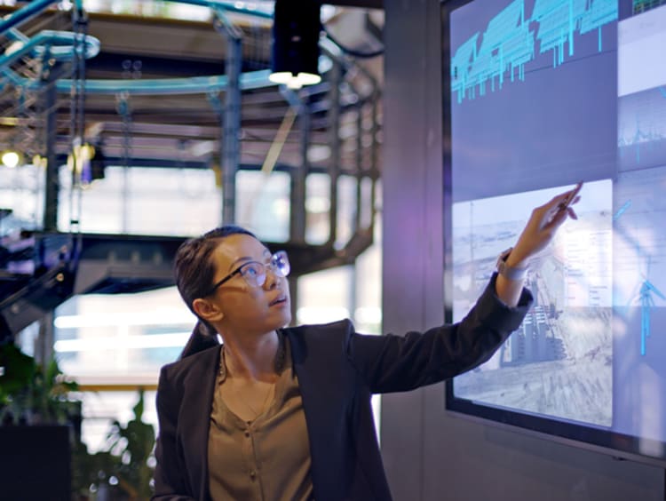 Female showing energy lecture on screen