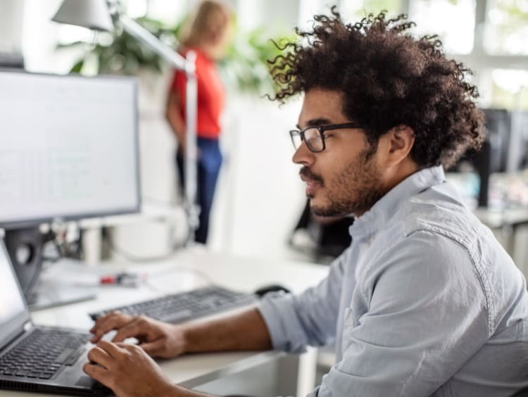 it support professional engages in virtual meeting on laptop