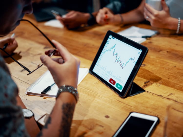 Man studies chart presented on his Ipad