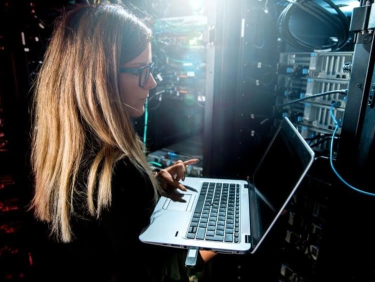 Female quality assurance analyst tests the functionality of a computer system 