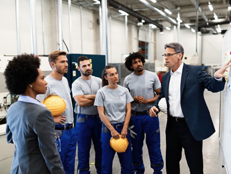 Male engineering manager presents a project to his team