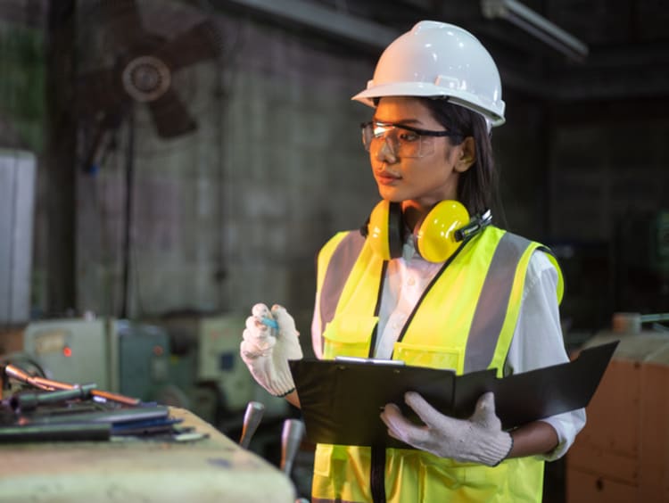 Female mechatronics engineer operates a machine