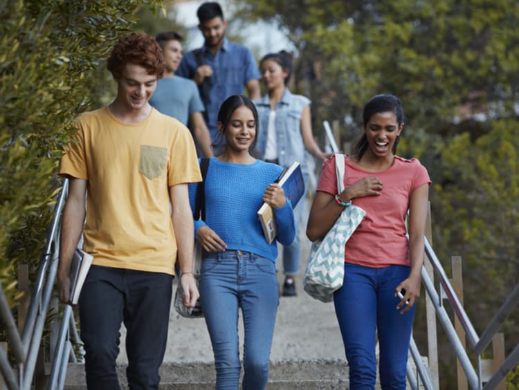students walking and discussing which college major to choose