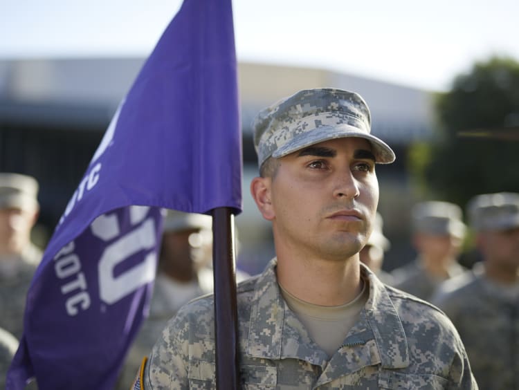 Man holding purple flag