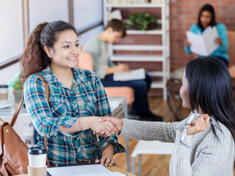 Student shaking hands with recruiter 