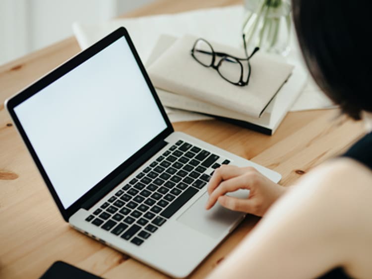 A woman writing an email at her computer