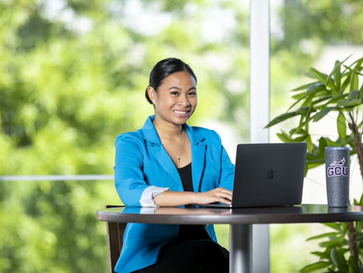 Faustina Deguzman at a computer for a military photo