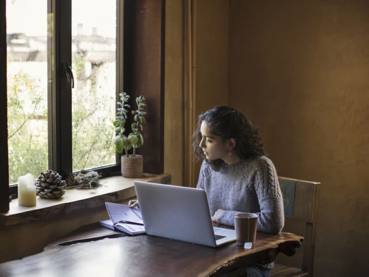 A young woman working on her online class from home