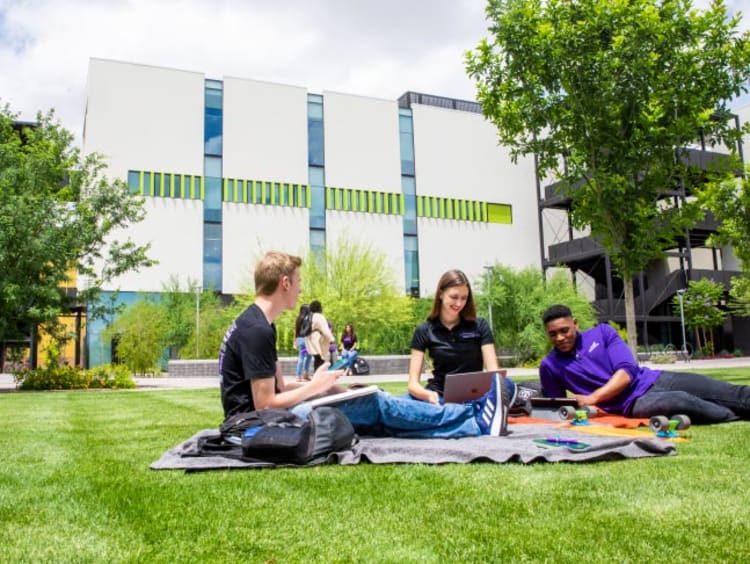 Honors students studying in front of the College of Business