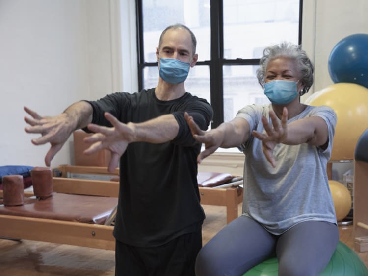 Male physical therapist working with female patient