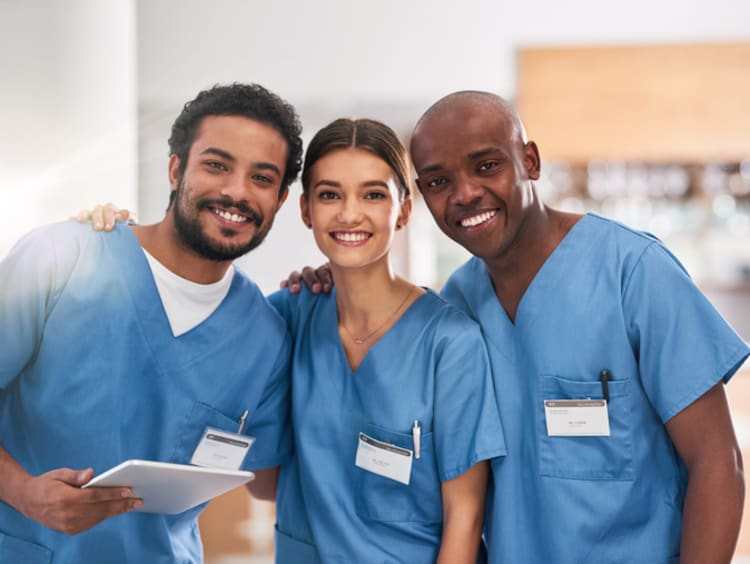 A portrait photo of three registered nurses inside a hospital 