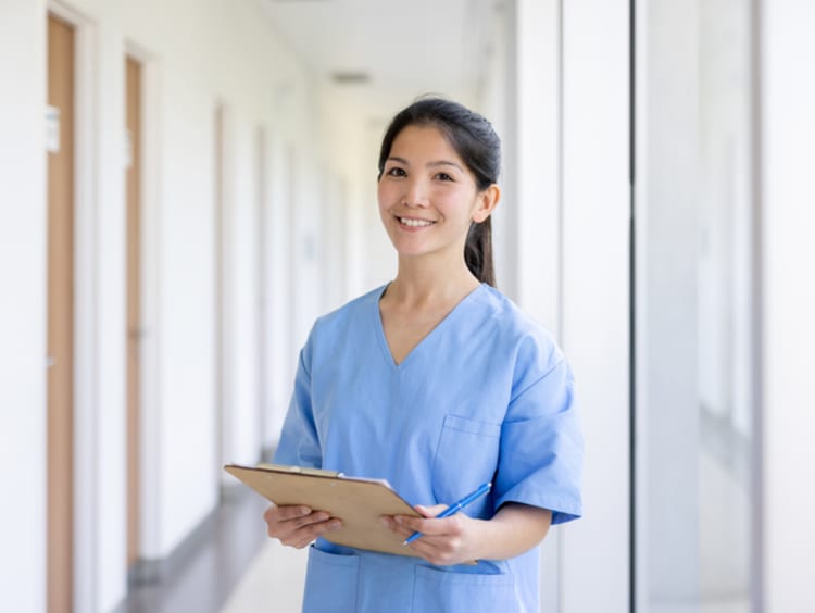 Nurse in hospital holding clipboard and getting nursing experience