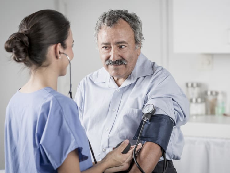 Nurse takes a patient's blood pressure