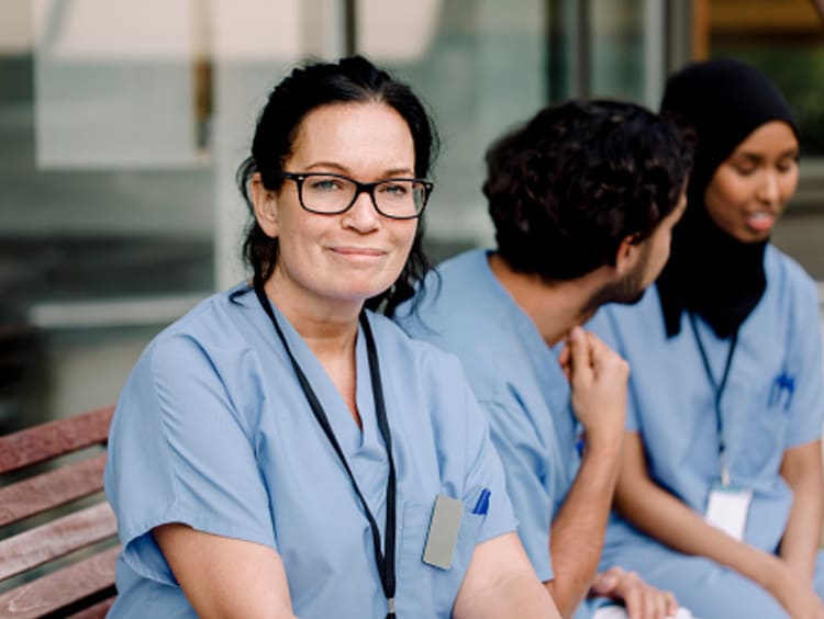 Nurses sitting on bench at hospital