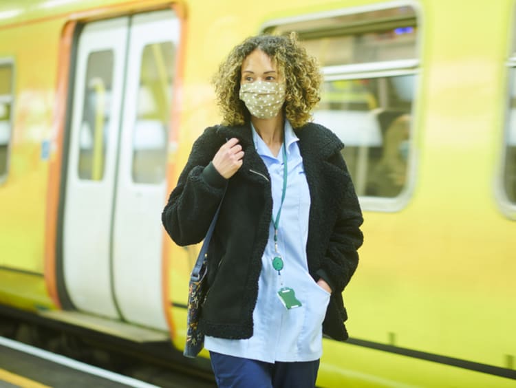 Travel nurse in front of subway