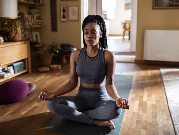 Woman practicing yoga at home