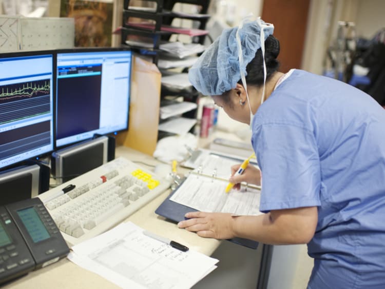 Nurse with an advanced nursing degree working on paperwork