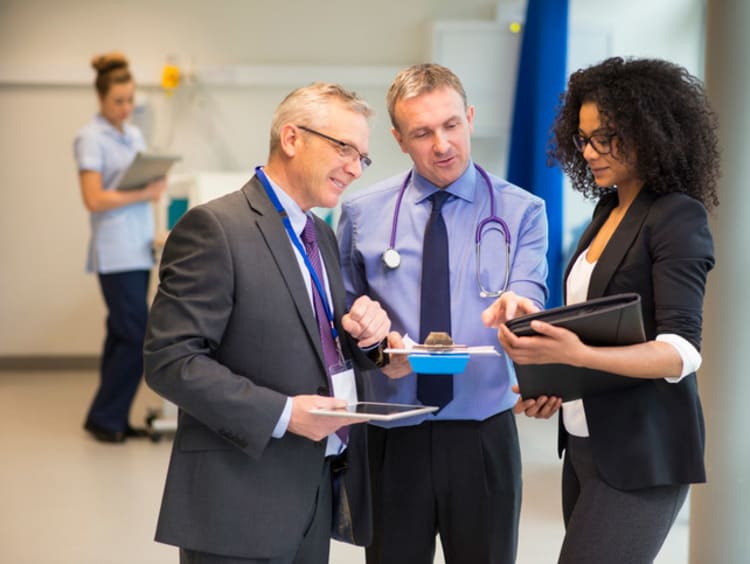 healthcare administrators having a conversation in a hallway