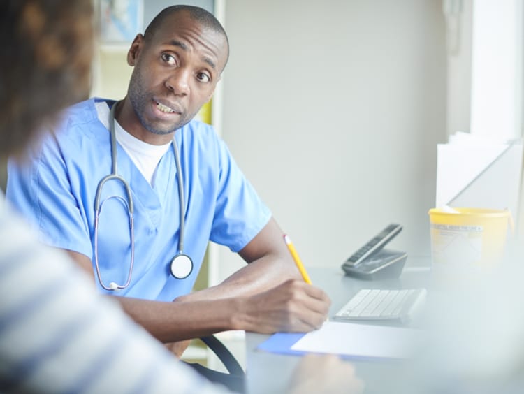 A male nurse talking with a patient