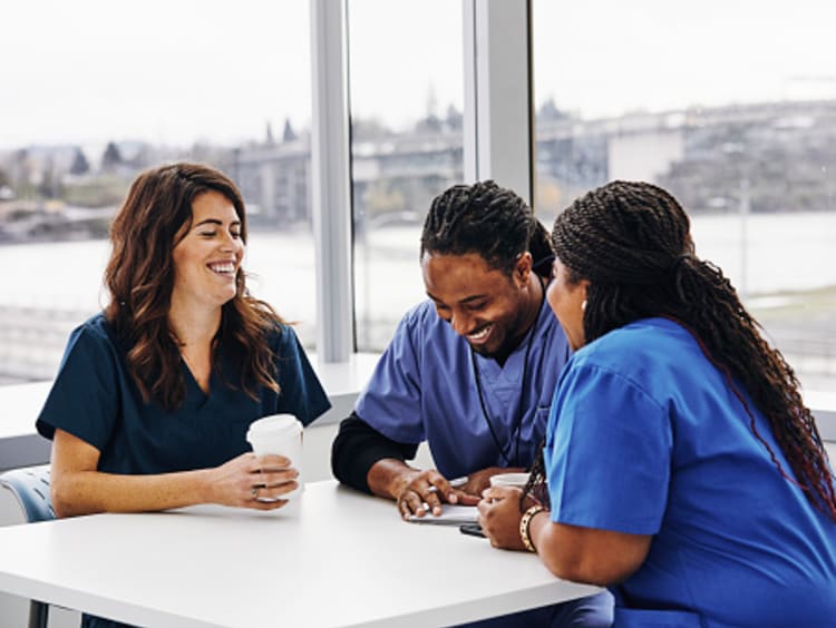 Nurses laughing together at work