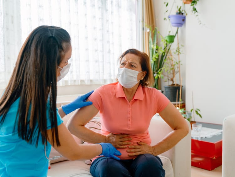 Nurse assisting pancreatic cancer patient