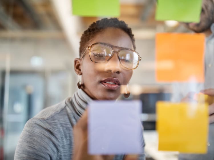 Creative director writing down notes about her ideas