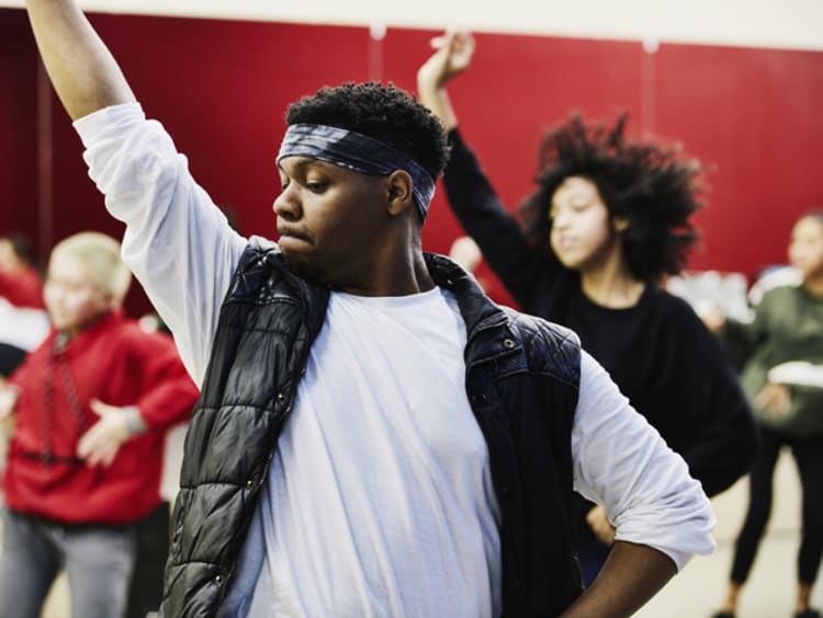 Dance teacher instructing class in studio