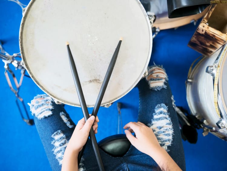 a person playing on the drums