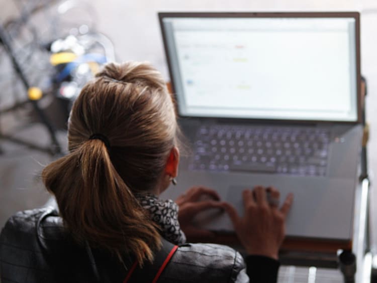 Script supervisor taking notes on computer