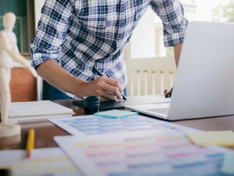 A designer working at his desk with a laptop