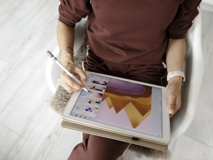 a student doing graphic design work on a tablet device