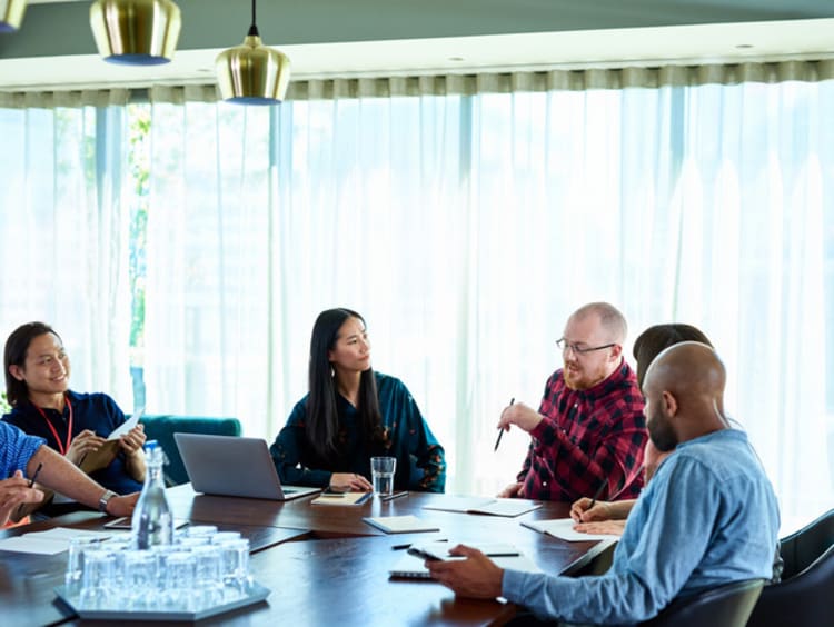 people sitting around a table talking