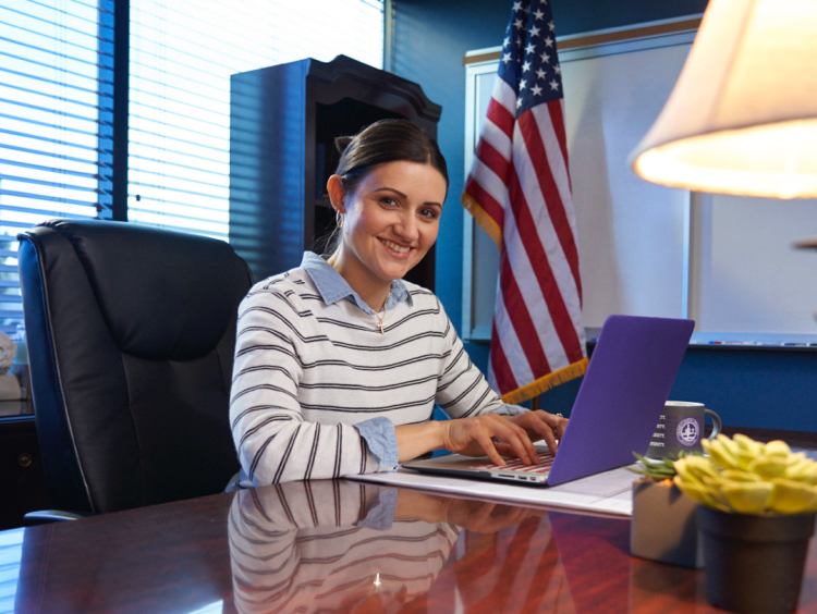 woman principle sits in office space