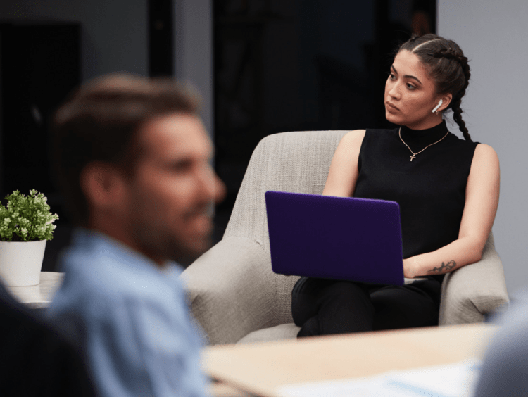 woman works at laptop with headphones in