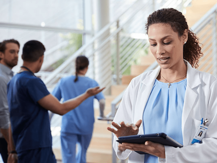 Woman medical admin uses an ipad in clinical setting