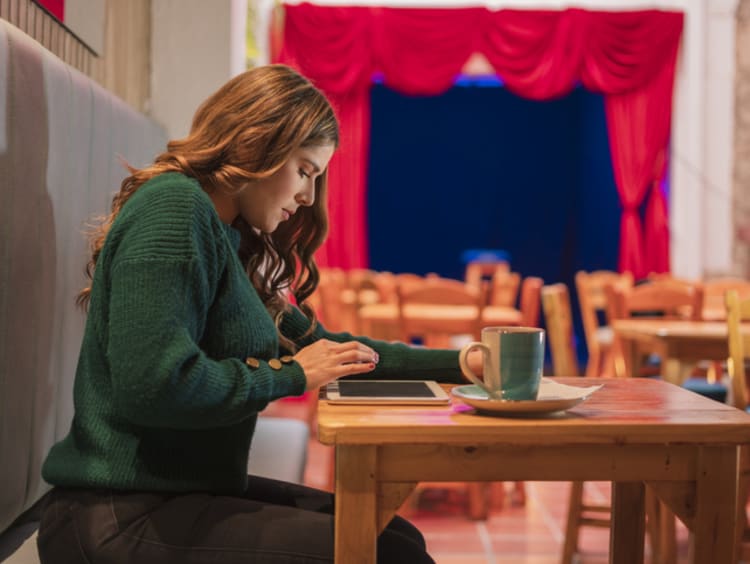 Woman posting on social media in cafe