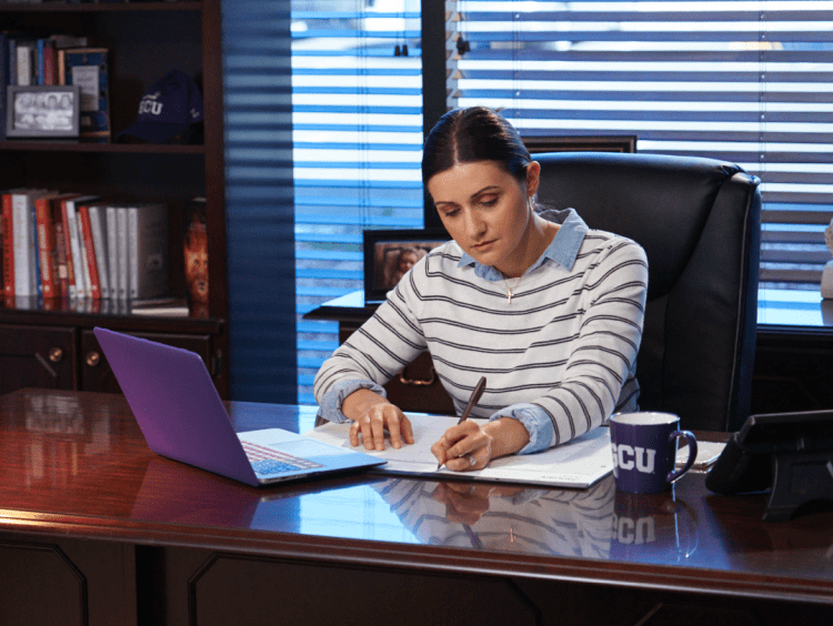 principal working in office space at desk